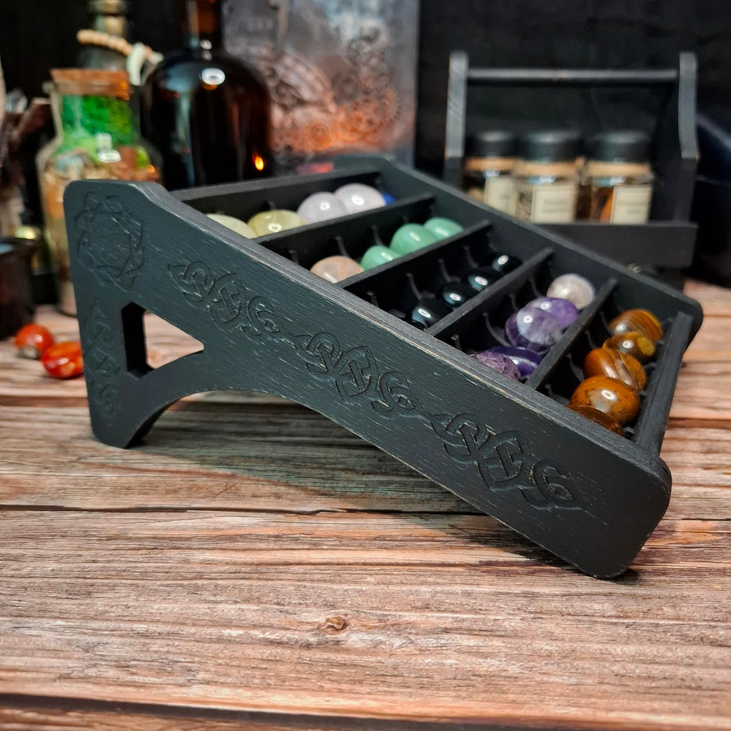 Wooden crystal storage shelf with decorative Celtic engraving.
