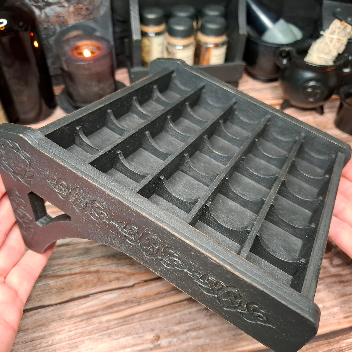 Wooden crystal storage shelf with decorative Celtic engraving and multiple crystal compartments.
