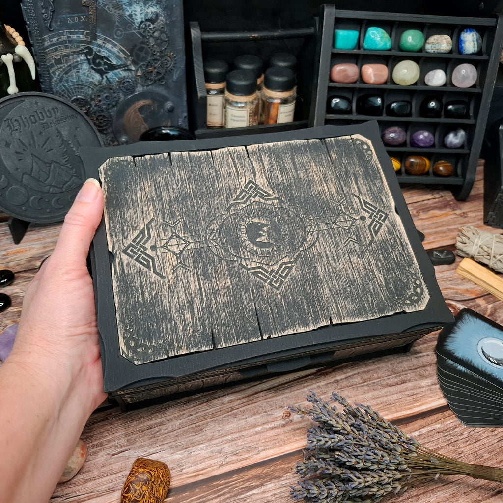 Top view of a handcrafted Celtic ritual storage box featuring an engraved wolf design on the wooden lid. Wooden organizer for crystals, herbs, tarot accessories, and ritual tools.
