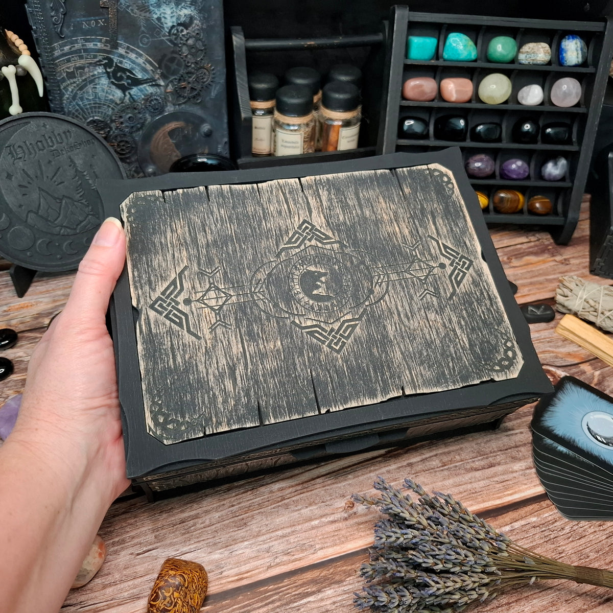 Top view of a handcrafted Celtic ritual storage box featuring an engraved wolf design on the wooden lid. Wooden organizer for crystals, herbs, tarot accessories, and ritual tools.
