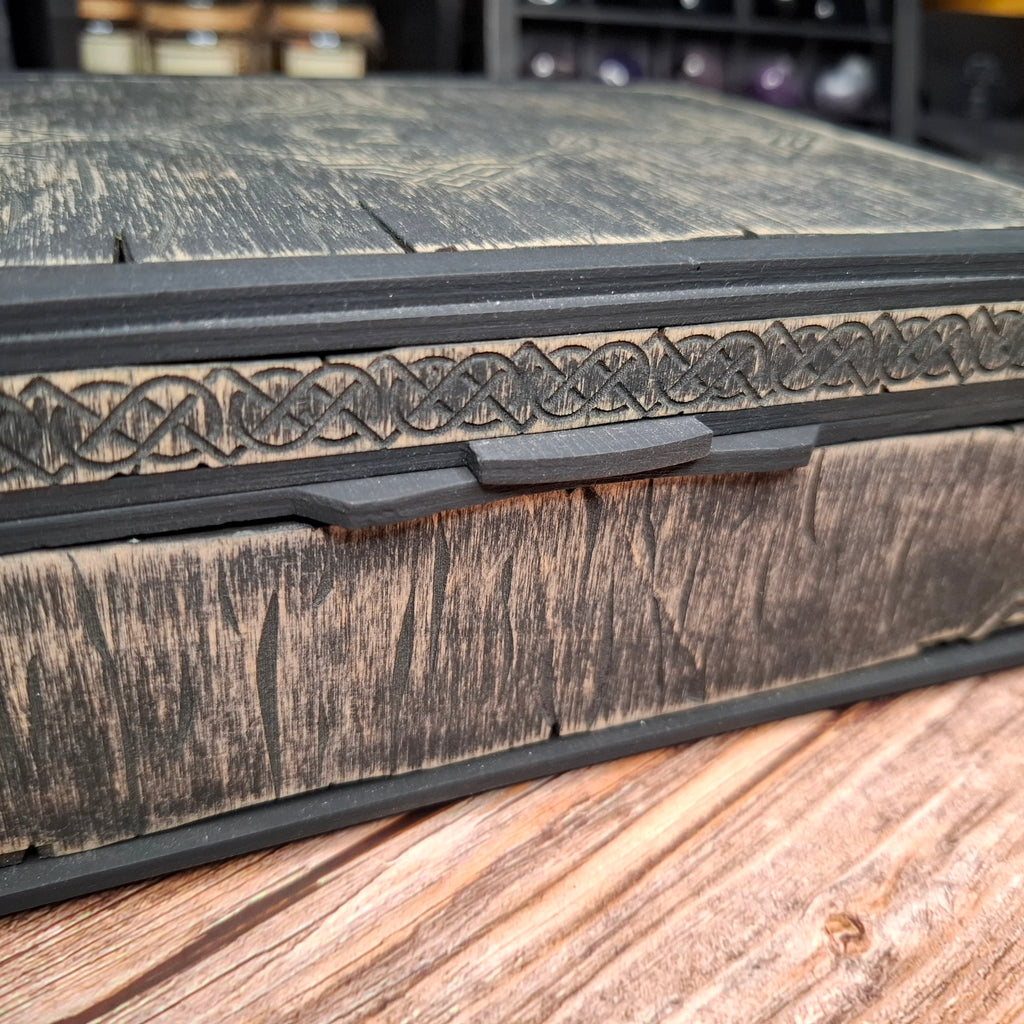 Close-up of the wooden lid pull on a handcrafted Celtic ritual storage box, highlighting the engraved Celtic knotwork and carefully crafted details.
