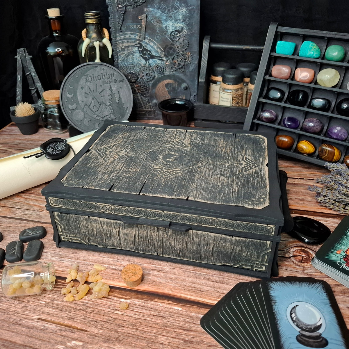 Handcrafted Celtic ritual storage box displayed among crystals, runes, tarot cards, and ritual tools, bringing beauty and organization to your magical space.

