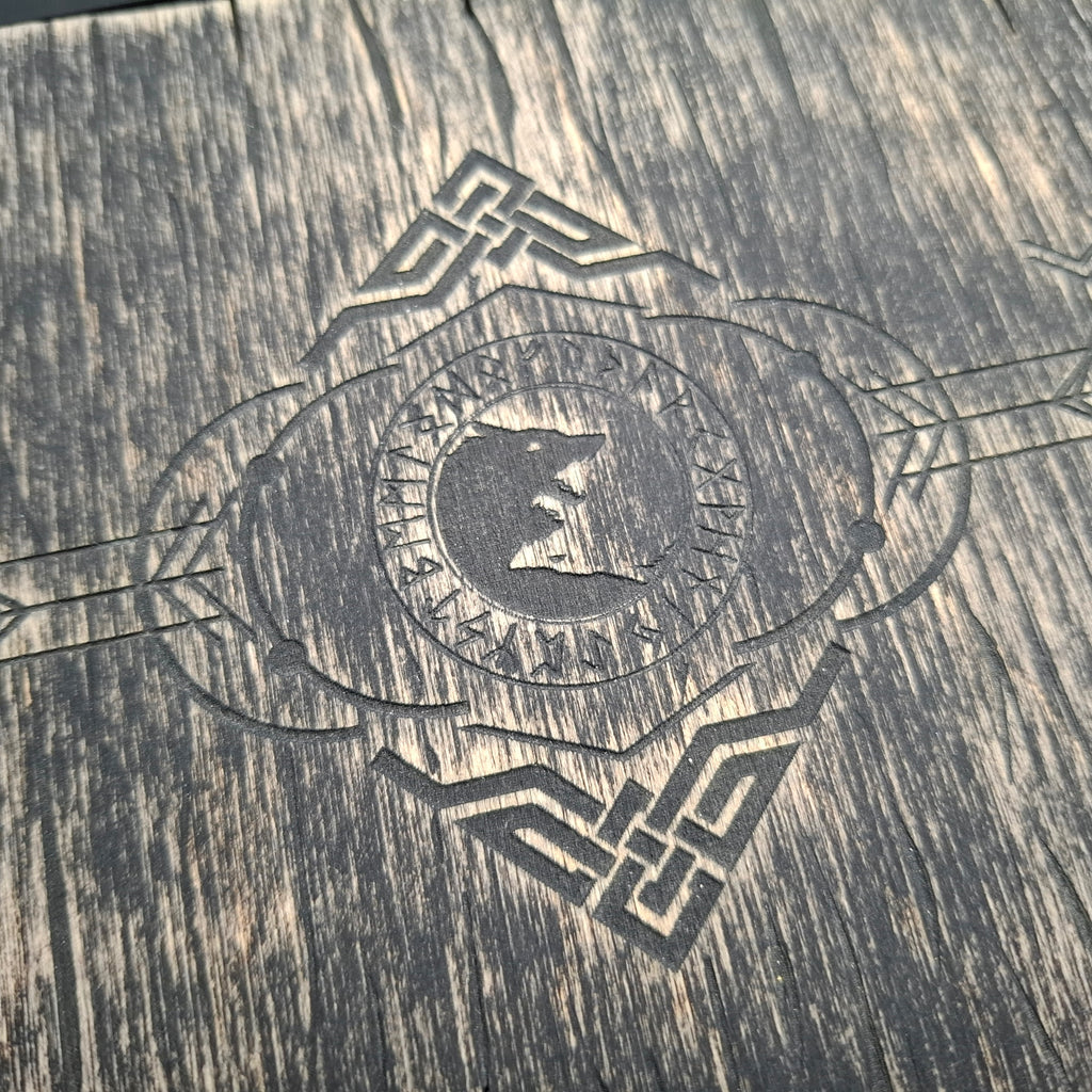 Close-up of the engraved wolf motif surrounded by runes on the lid of a handcrafted Celtic ritual storage box, highlighting the intricate laser-engraved details.
