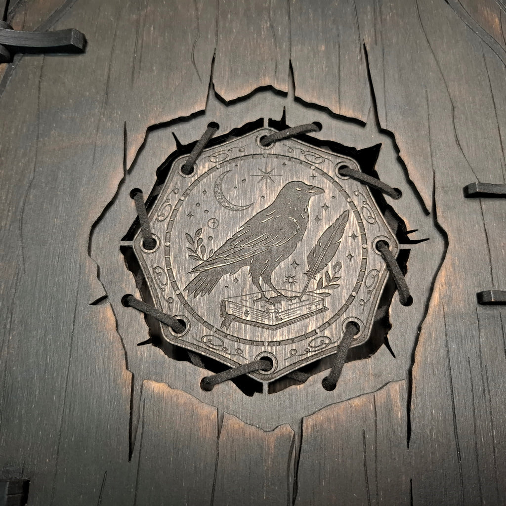 Engraved raven symbol detail on wooden witch book box
