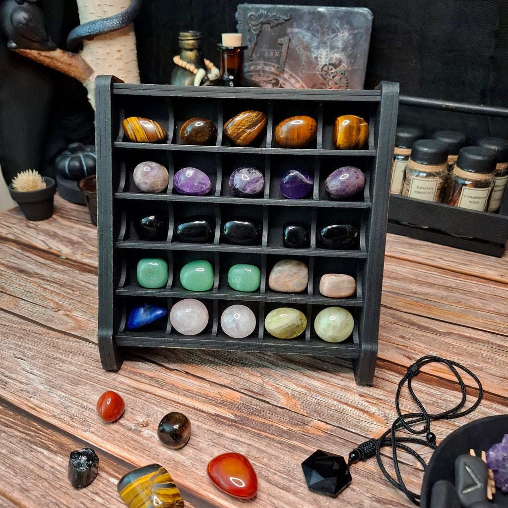 Large wooden crystal storage shelf filled with polished gemstones and crystals.
