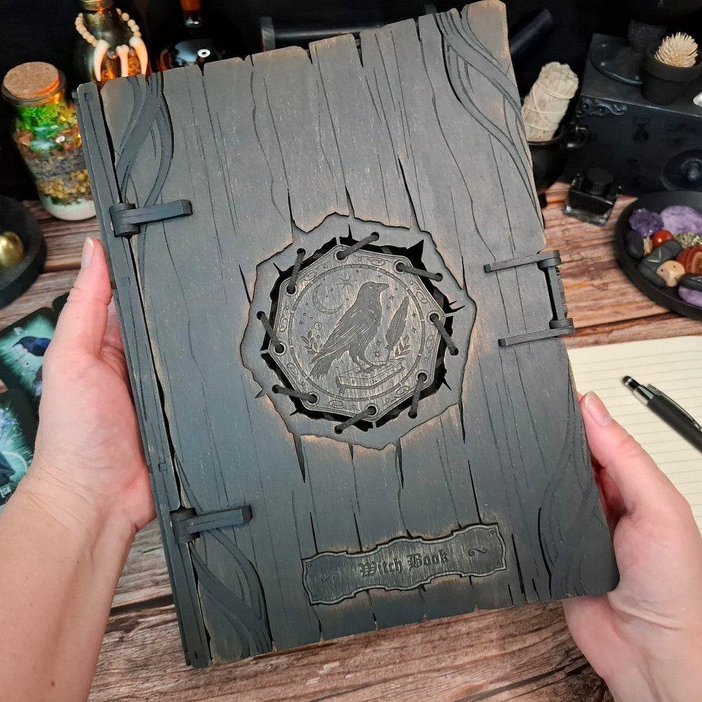 Large handcrafted raven witch book box shown held in both hands