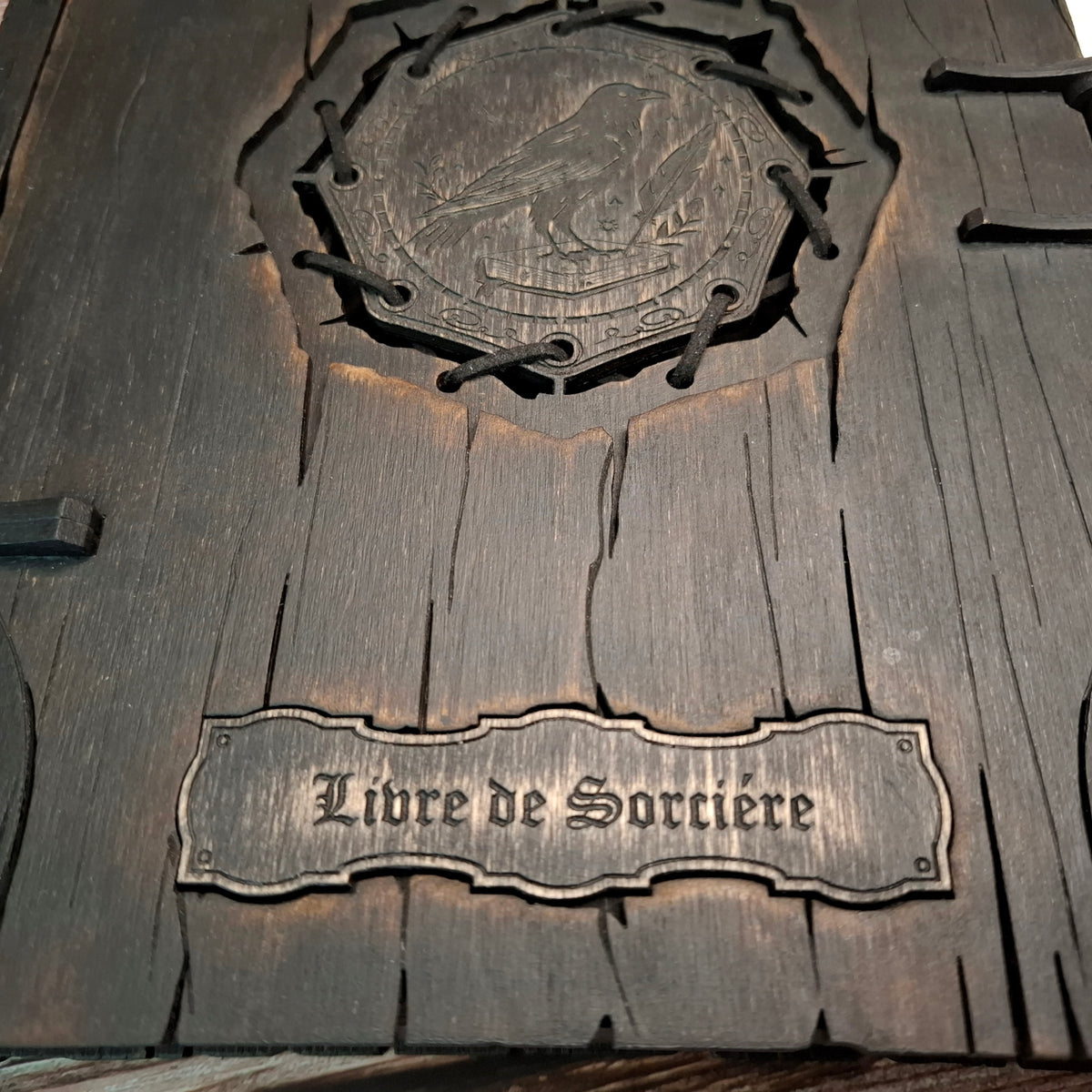 Close-up of the French “Livre de Sorcière” text engraved into the wooden cover