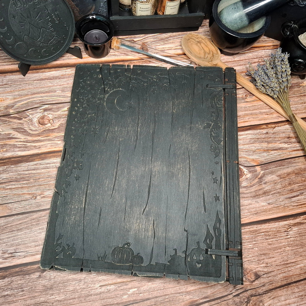 Back cover of a handmade wooden recipe binder with rustic grimoire styling