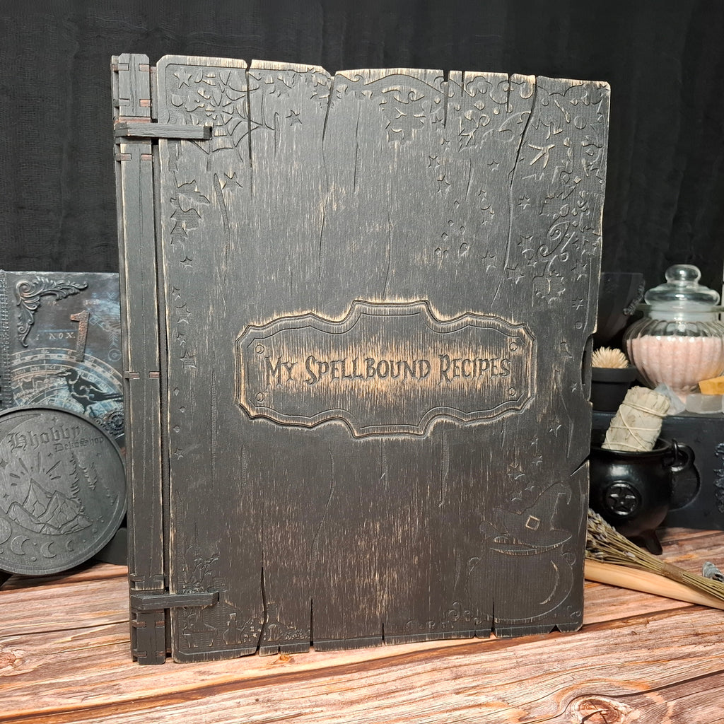 Handmade wooden recipe binder titled My Spellbound Recipes shown from the front