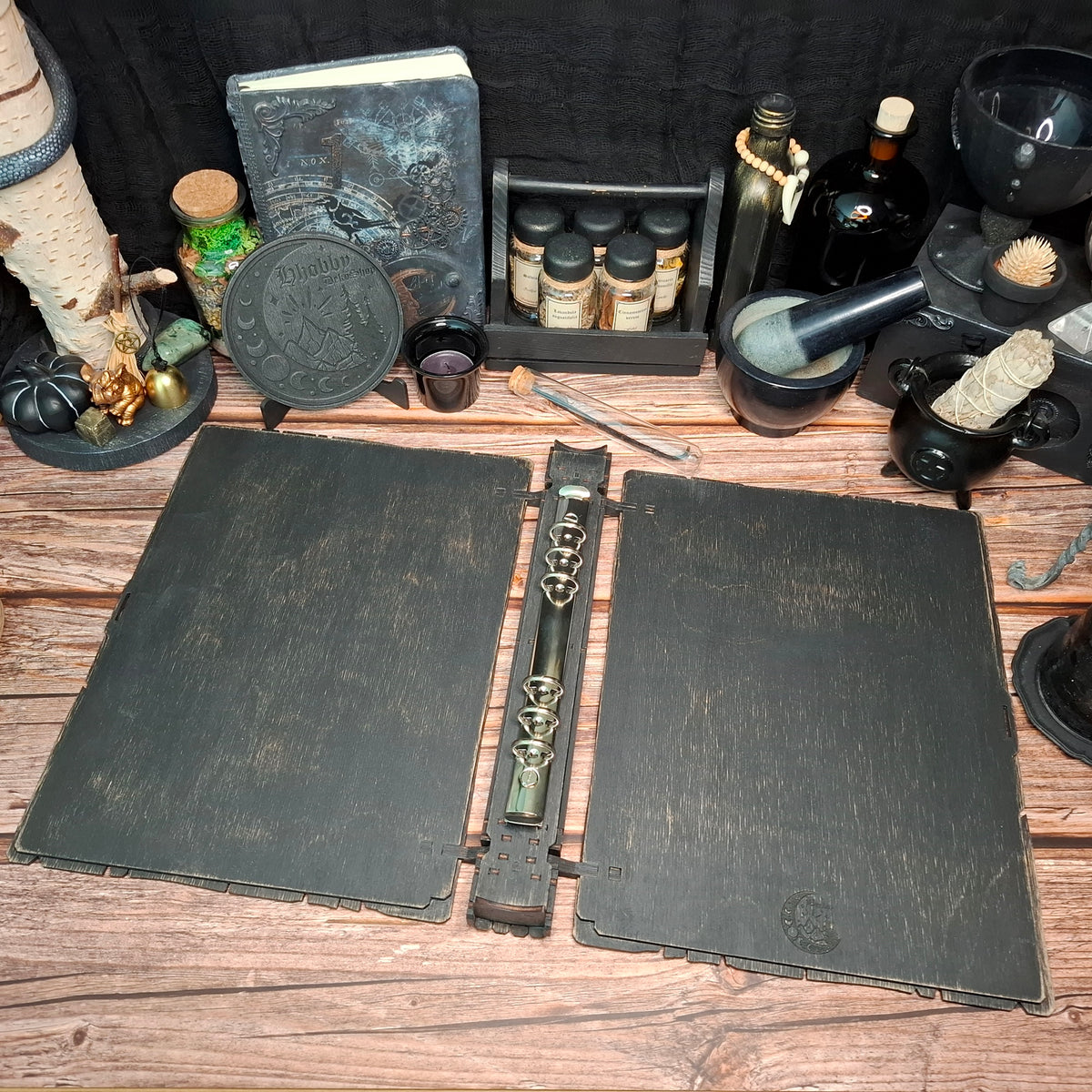 Open handmade wooden recipe binder showing the ring binding system