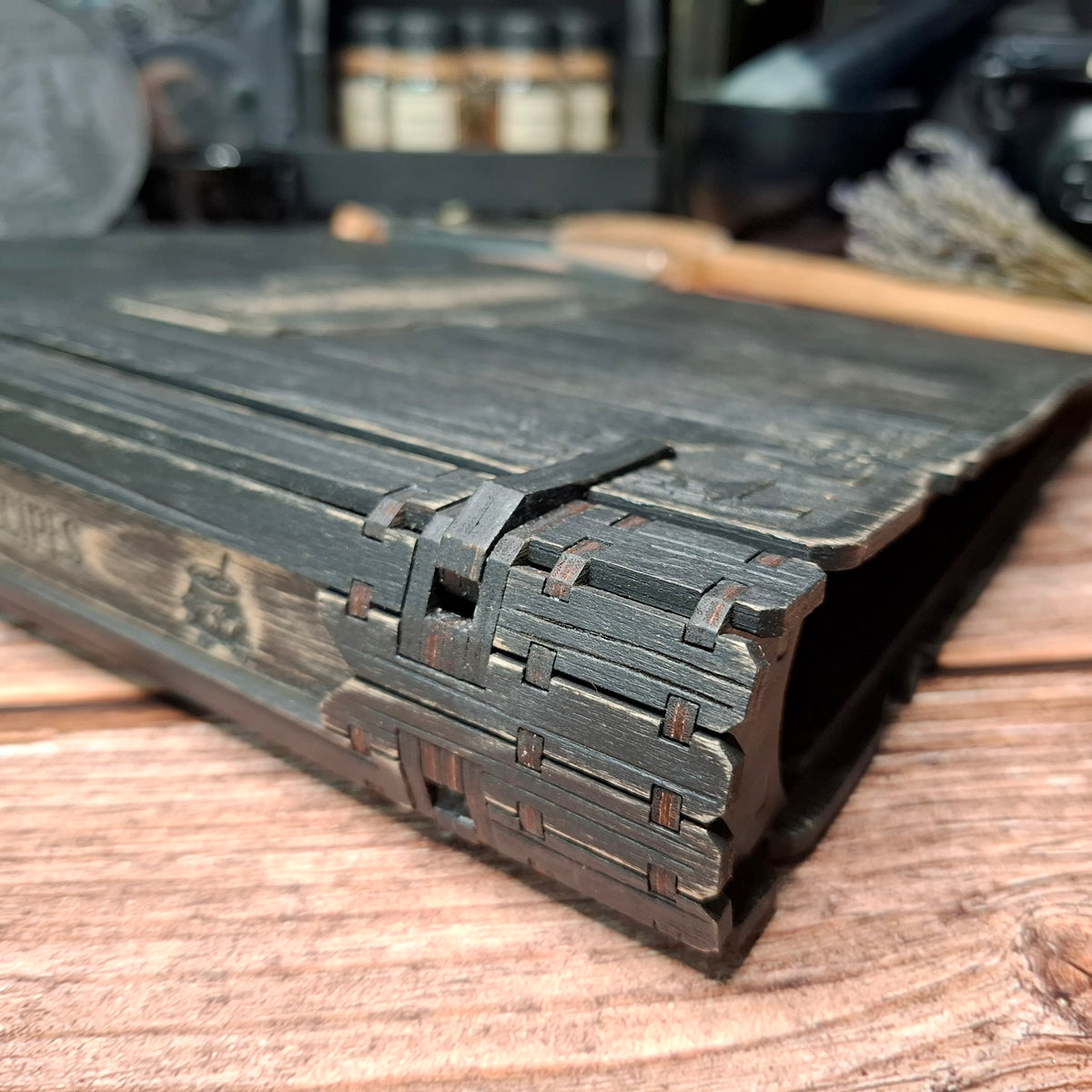 Close-up of the handcrafted spine and hinge details on a wooden recipe binder
