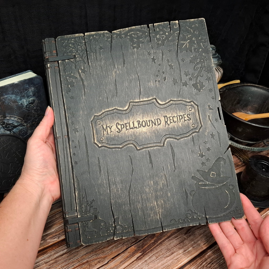 Handmade My Spellbound Recipes wooden binder held in hand showing its size and craftsmanship