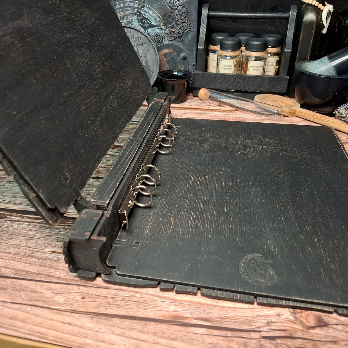 Open interior view of a handmade wooden recipe binder with ring system