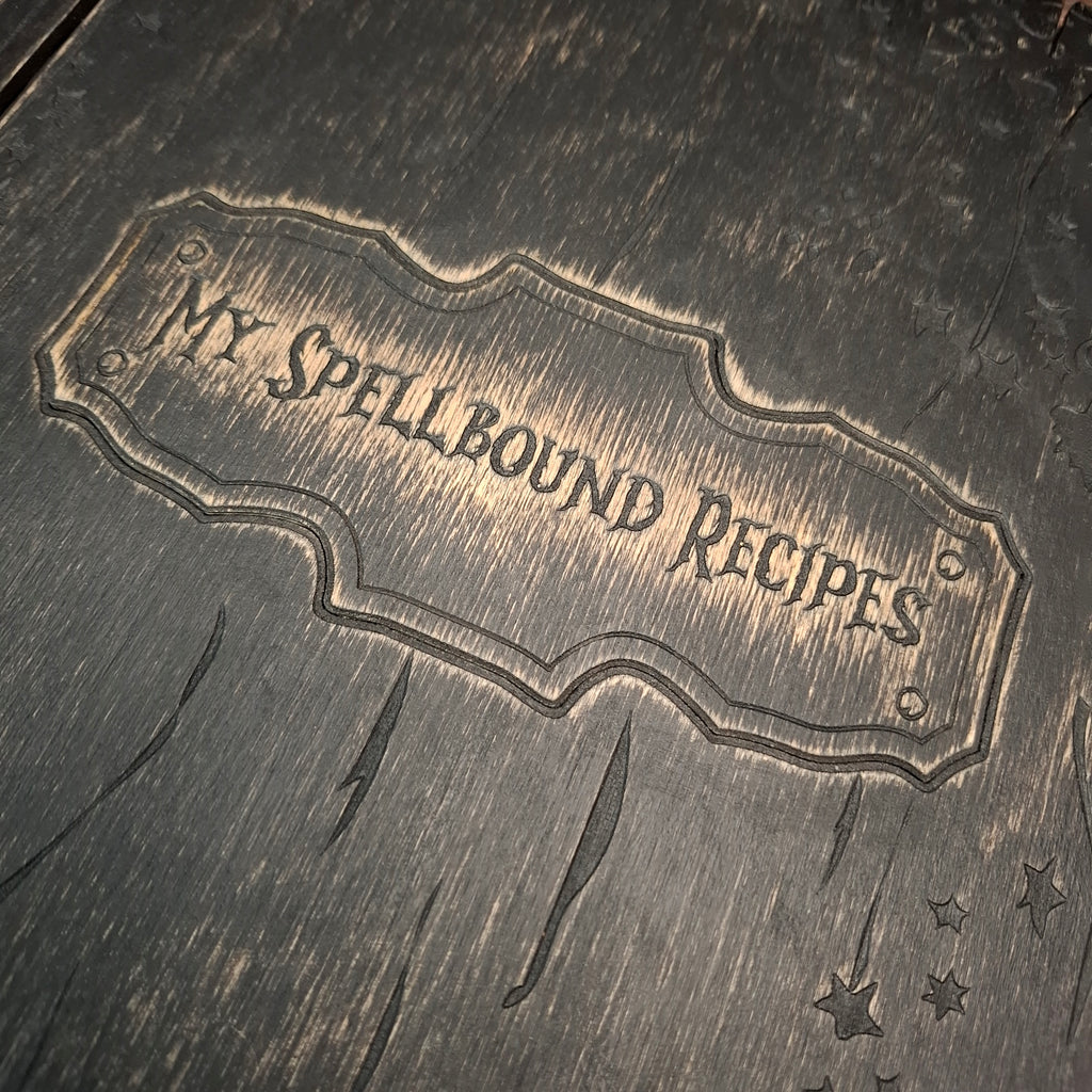 Close-up of the engraved My Spellbound Recipes title on the wooden cover