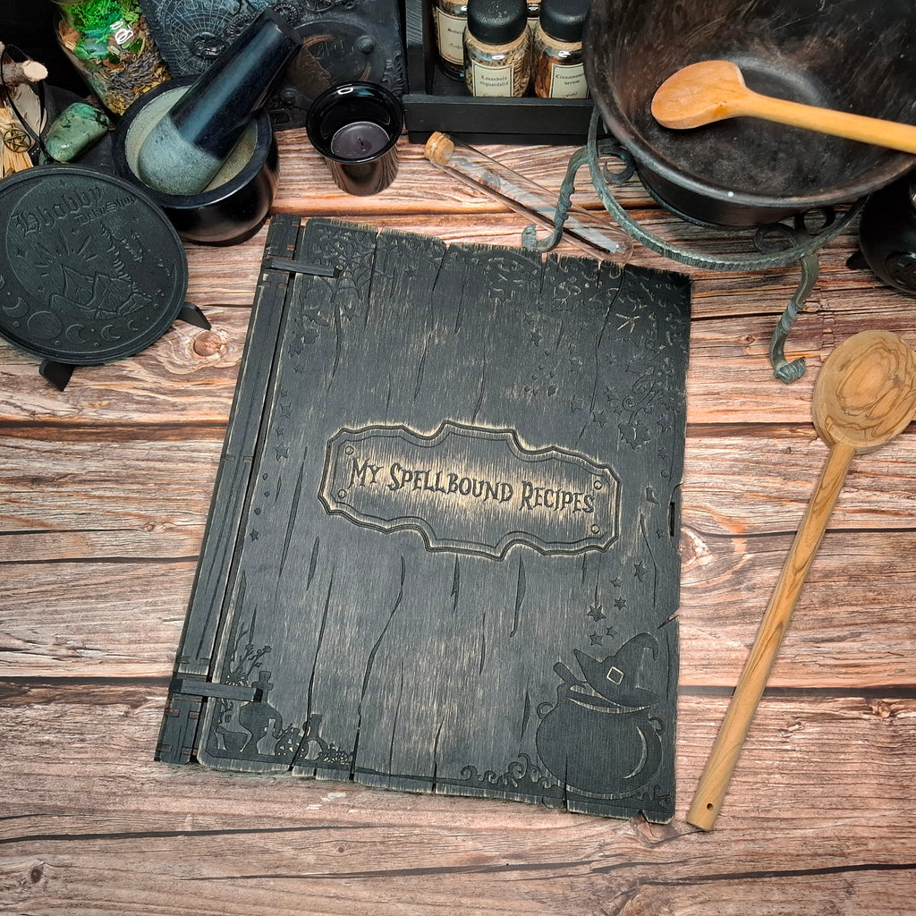 Top view of the My Spellbound Recipes wooden binder with engraved cover details