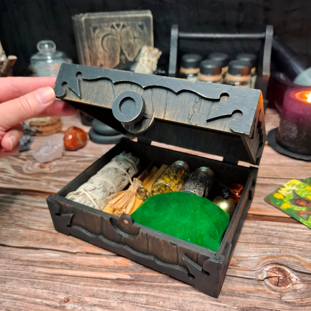 Side view of a handmade wooden pentagram ritual box filled with ritual supplies