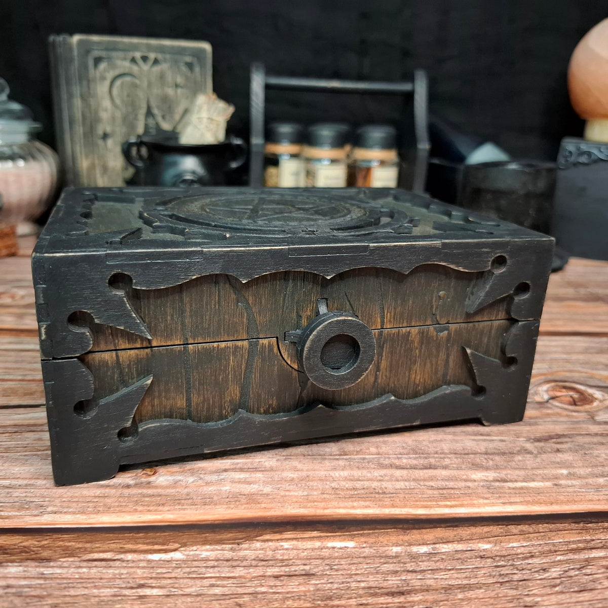 Close-up of the decorative handle and front panel of a handmade wooden pentagram ritual box