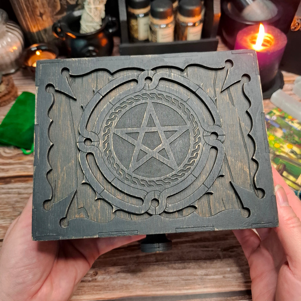 Handmade wooden pentagram ritual box held in hand showing the engraved lid design