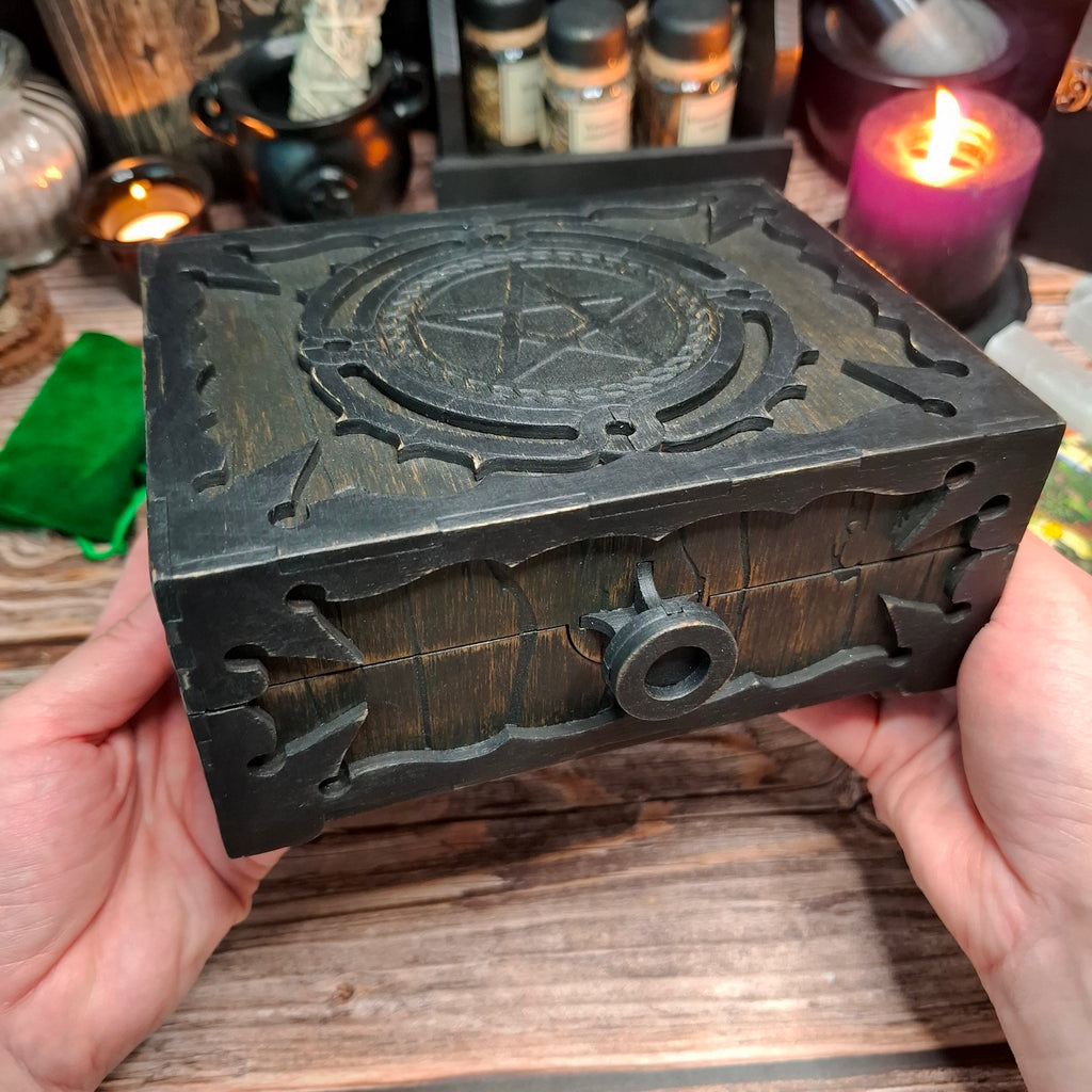Handmade wooden pentagram ritual box shown in hand from the side