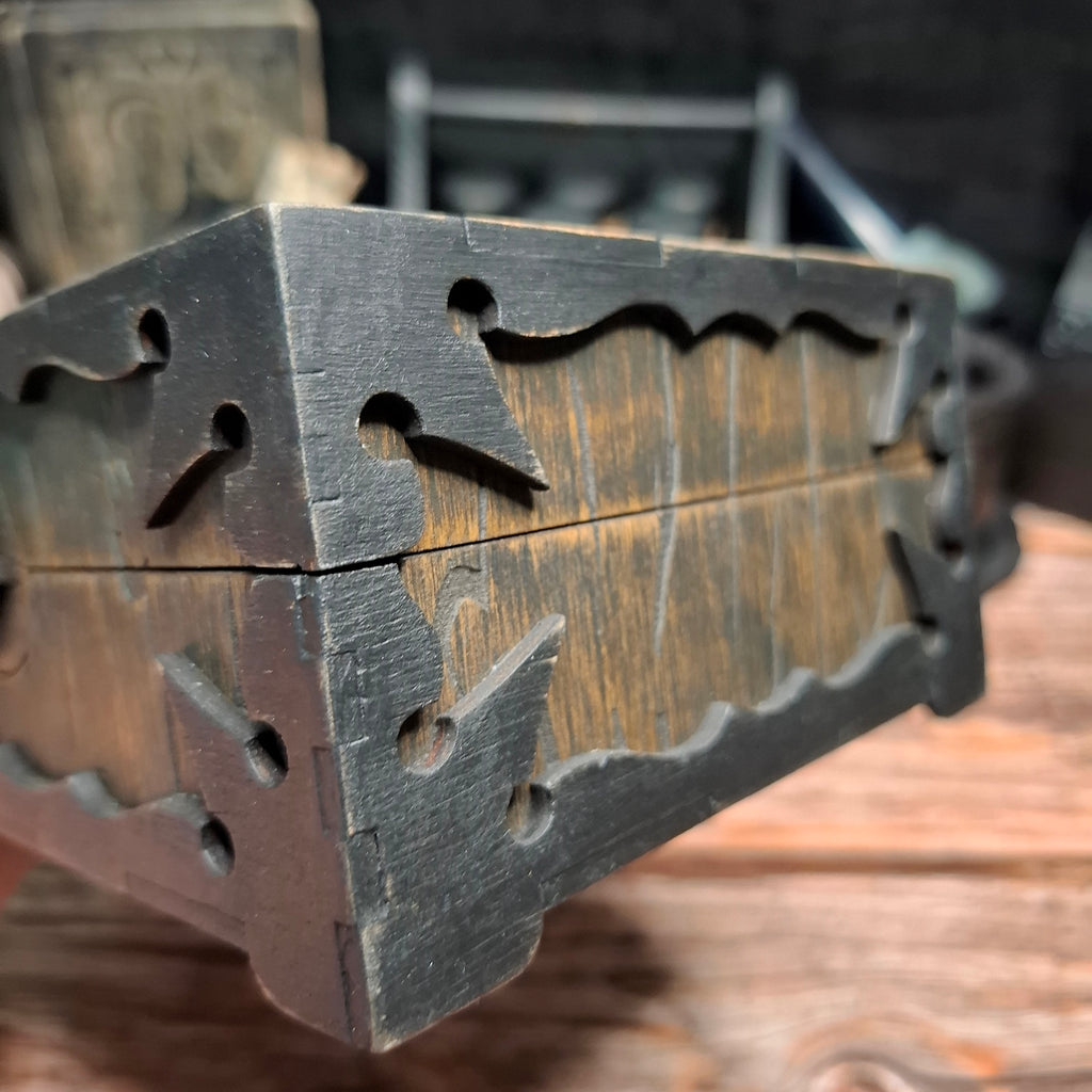 Detailed side view of a handmade wooden pentagram ritual box showing layered construction