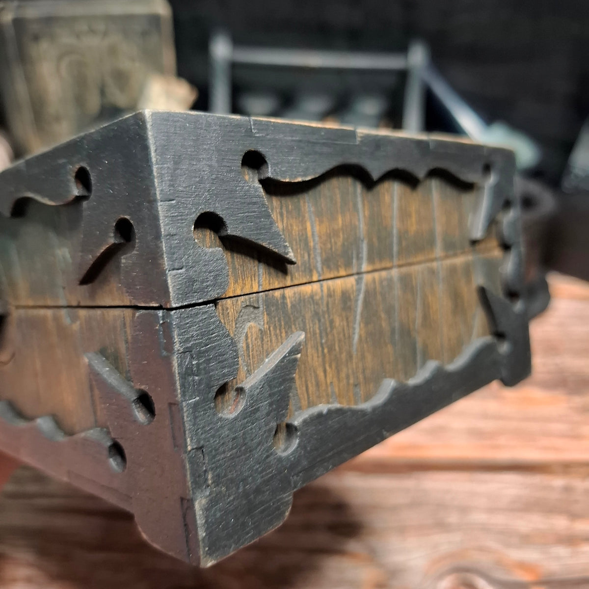 Detailed side view of a handmade wooden pentagram ritual box showing layered construction