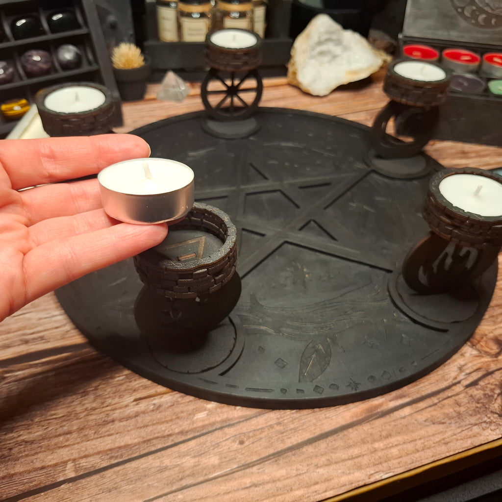 Placing a standard tea light candle into a handmade wooden ritual candle holder