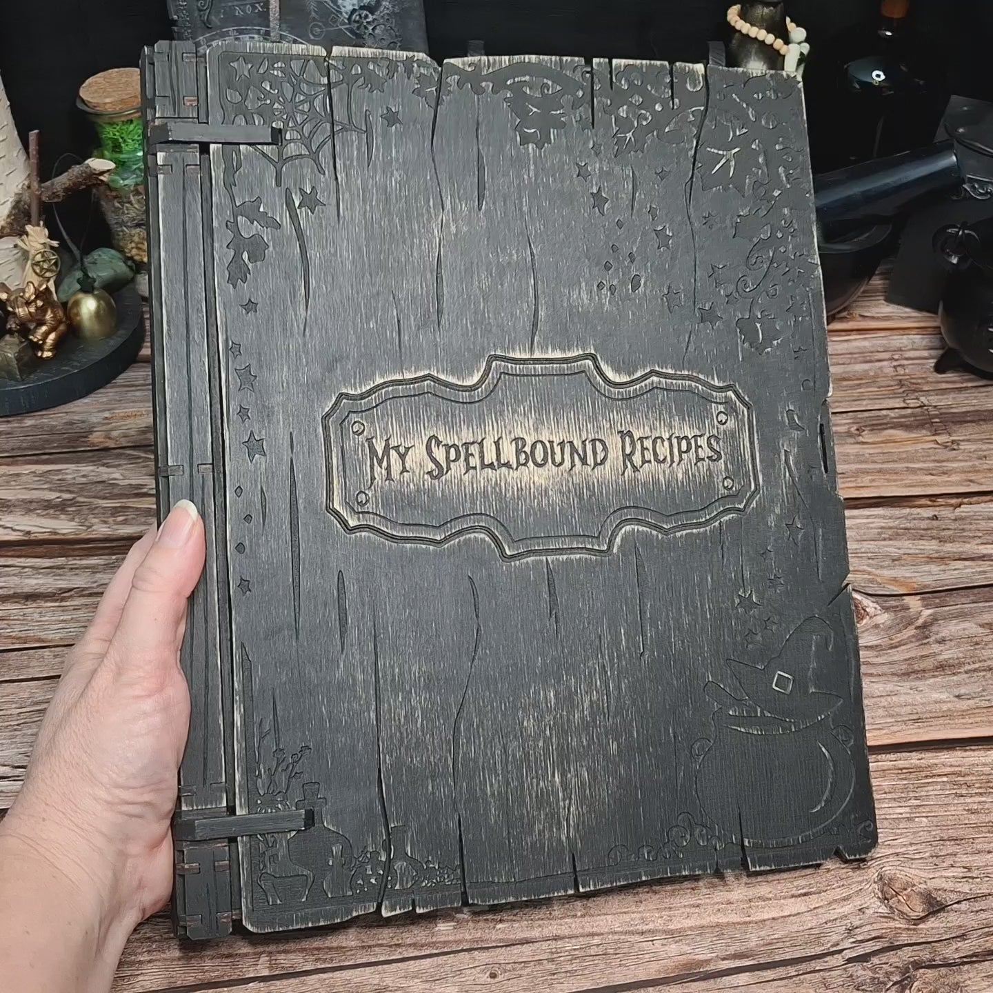 Demonstration of the handmade My Spellbound Recipes wooden recipe binder, showing the ring binding system, page organization and personalization options
