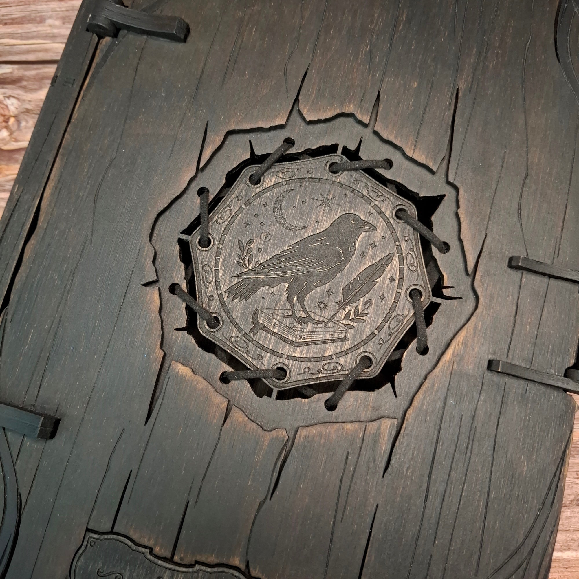 Central raven symbol detail on handmade witch book box