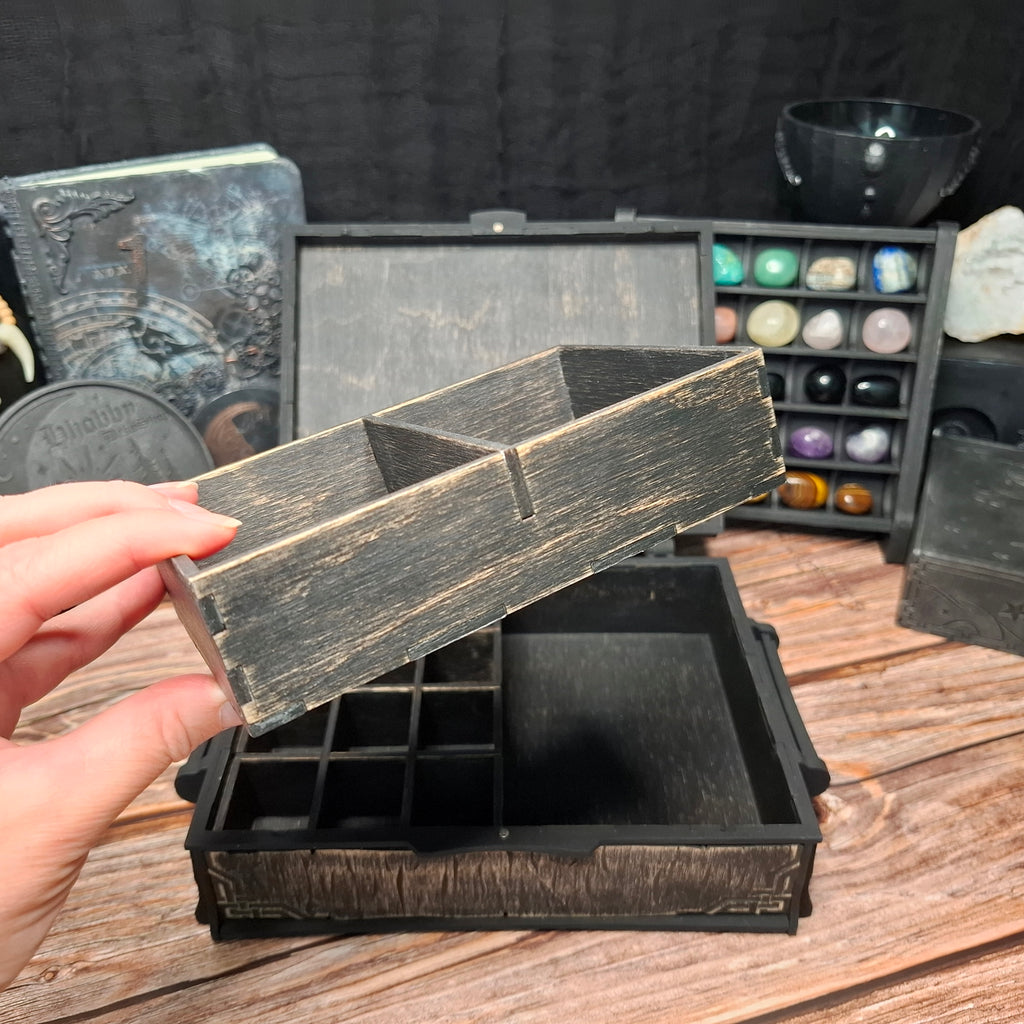 The removable organizer tray with spacious compartments, designed for storing cards, pendulums, incense, and other small ritual tools inside the Celtic ritual storage box.
