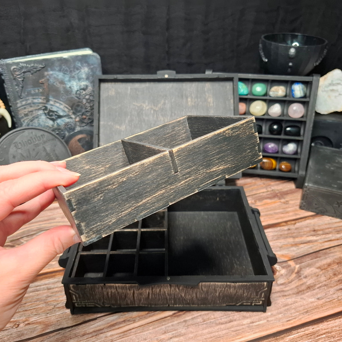 The removable organizer tray with spacious compartments, designed for storing cards, pendulums, incense, and other small ritual tools inside the Celtic ritual storage box.
