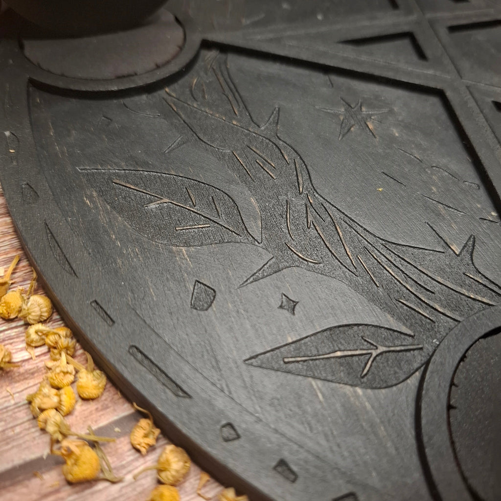 Close-up of engraved leaf and nature-inspired details on a wooden ritual altar tray