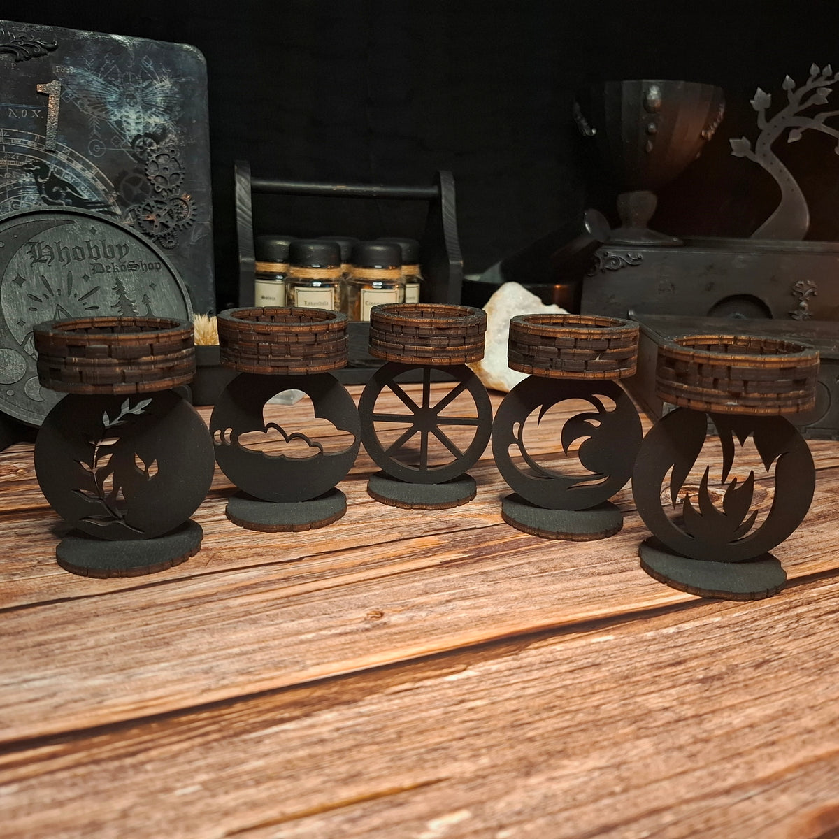Set of five handmade wooden ritual tea light candle holders with different elemental and mystical designs
