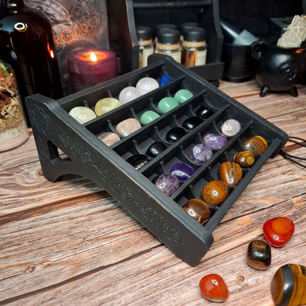Small wooden crystal storage shelf displaying polished crystal specimens.
