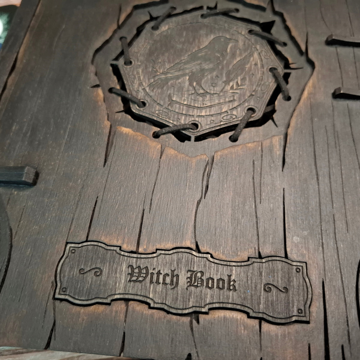 Close-up of the English “Witch Book” engraving on the handcrafted wooden grimoire box
