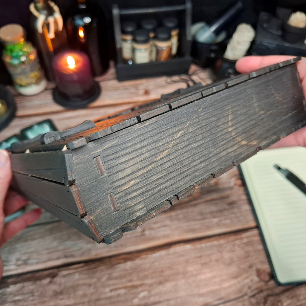 Side profile of the handcrafted wooden witch book storage box designed like an old tome